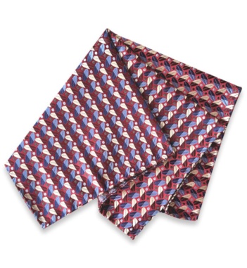 Folded burgundy jacquard silk pocket square with a repeating blue and ivory motif