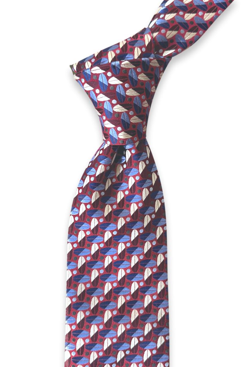 Knotted red jacquard silk tie showing multicolored oval motifs with diagonal details and contrasting dots