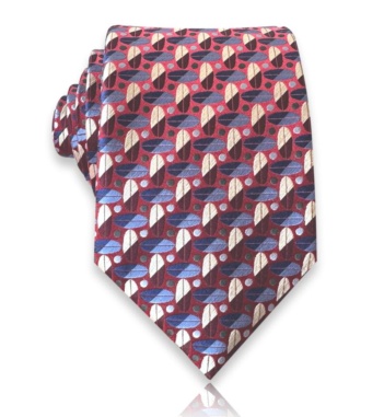 Red jacquard silk tie with alternating blue, navy, ivory, and burgundy oval motifs and small dots