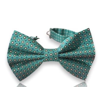 Neven green silk bow tie with small brown and cream circular motifs and an adjustable neck strap on a white background.