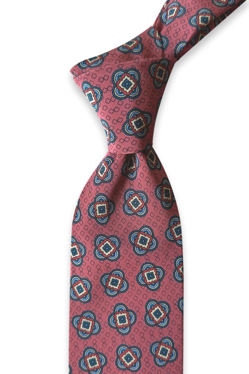 reddish-brown silk twill tie with navy and ivory ornamental medallions and small geometric details