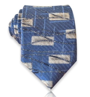Blue silk twill tie with gray geometric shapes, fine blue grid lines, and sweeping dark accents